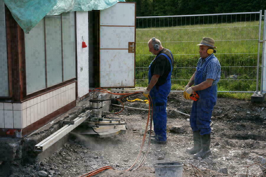 Mit einer speziellen Betonsäge trennen Experten das Tankwarthäuschen vom Fundament.